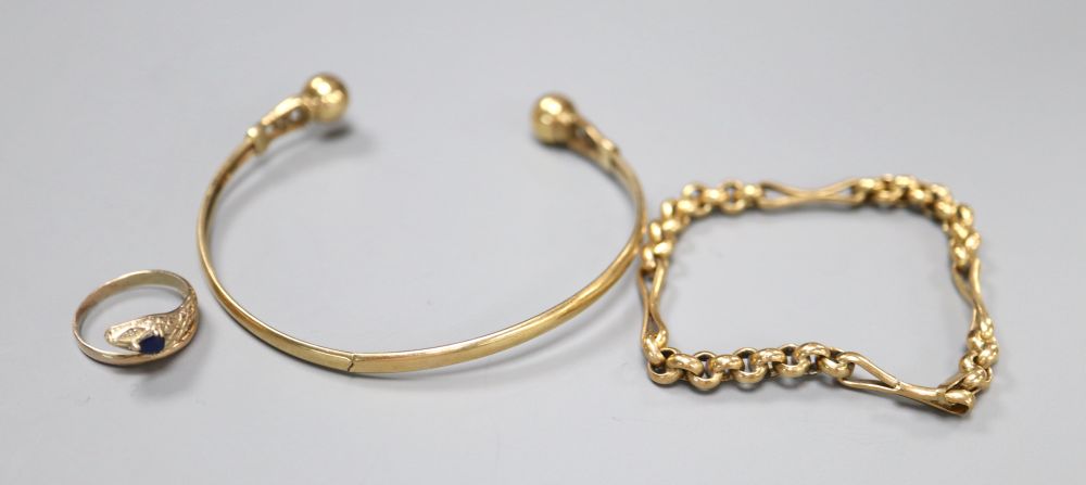 A yellow metal bangle, a yellow metal small chain bracelet and a yellow metal gem set cobra ring,